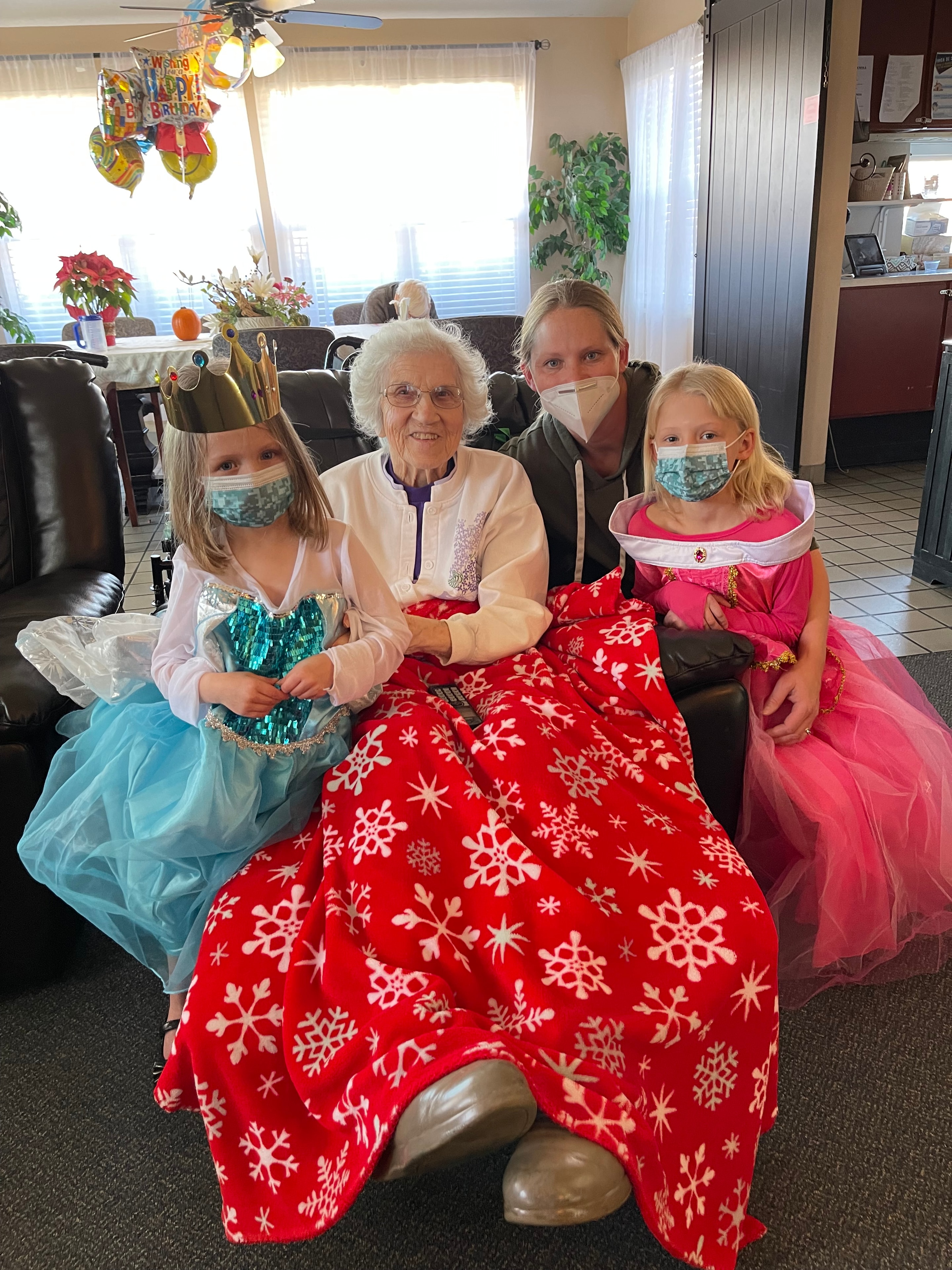 Children in princess costumes visiting their great grandmother